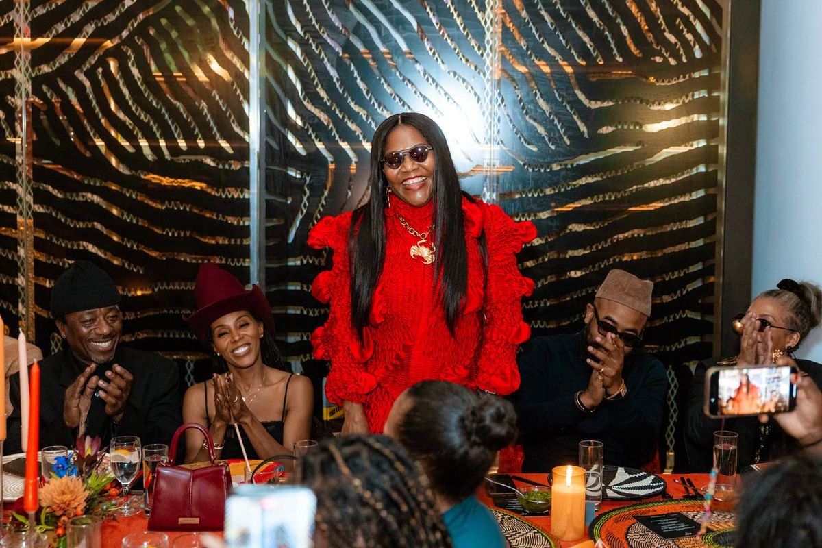 Alára founder, Reni Folawiyo, surrounded by guests at the Alára private dinner at The Norm, Brooklyn Museum.