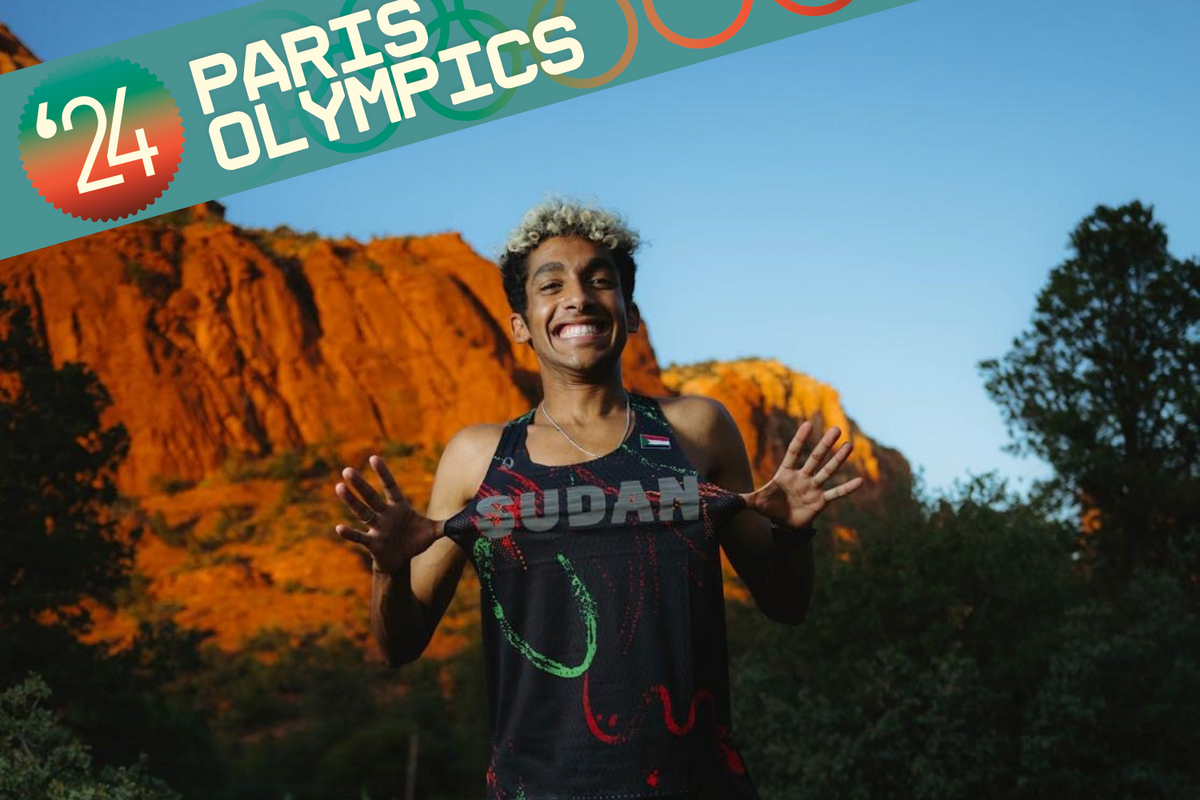 Abdalla smiling, posing in his Sudan running kit. 