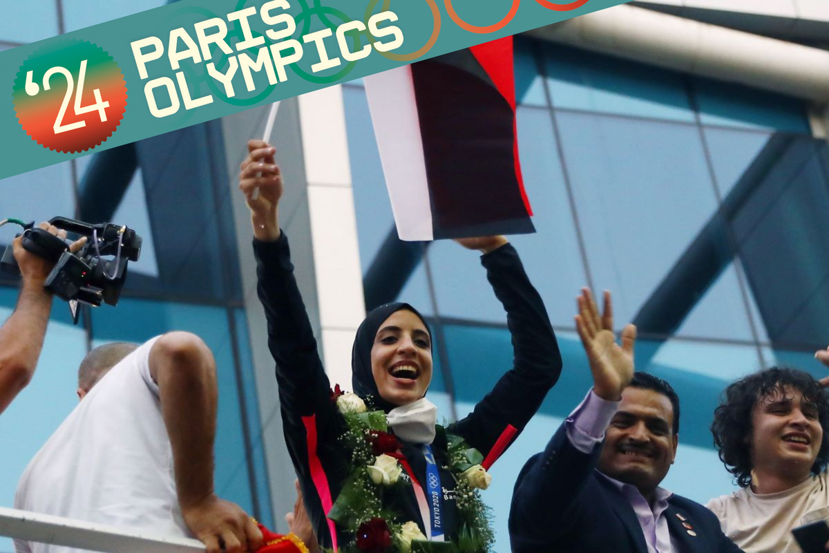 Egyptian karateka Feryal Abdelaziz 3rd R, who won the gold medal in women's +61kg Kumite at Tokyo 2020, is honored with cheers from Egyptian fans upon arrival at Cairo International Airport in Cairo, Egypt, on Aug. 12, 2021.